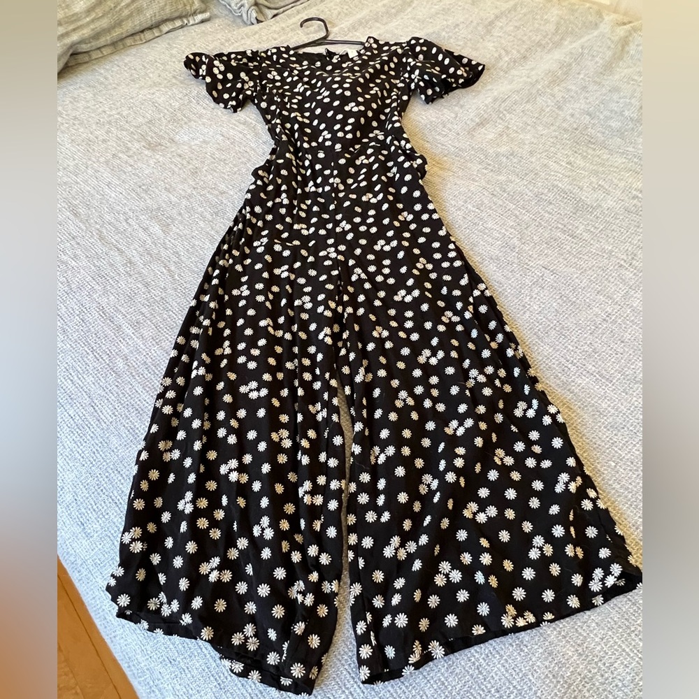 Black romper with white daisies.